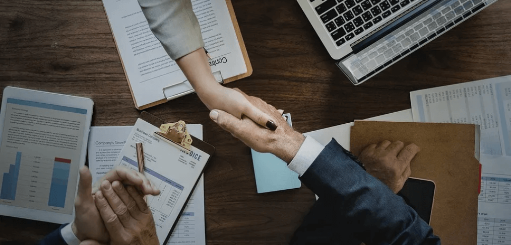 handshake over a work desk